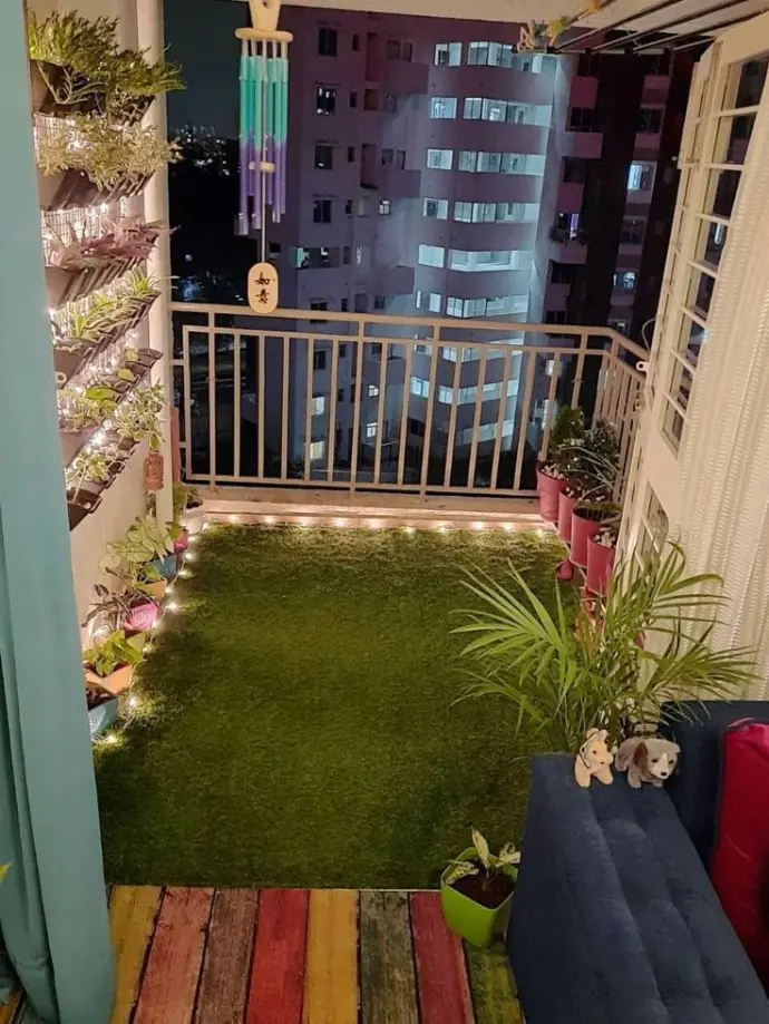 Balcony garden setup with vertical planters and turf flooring