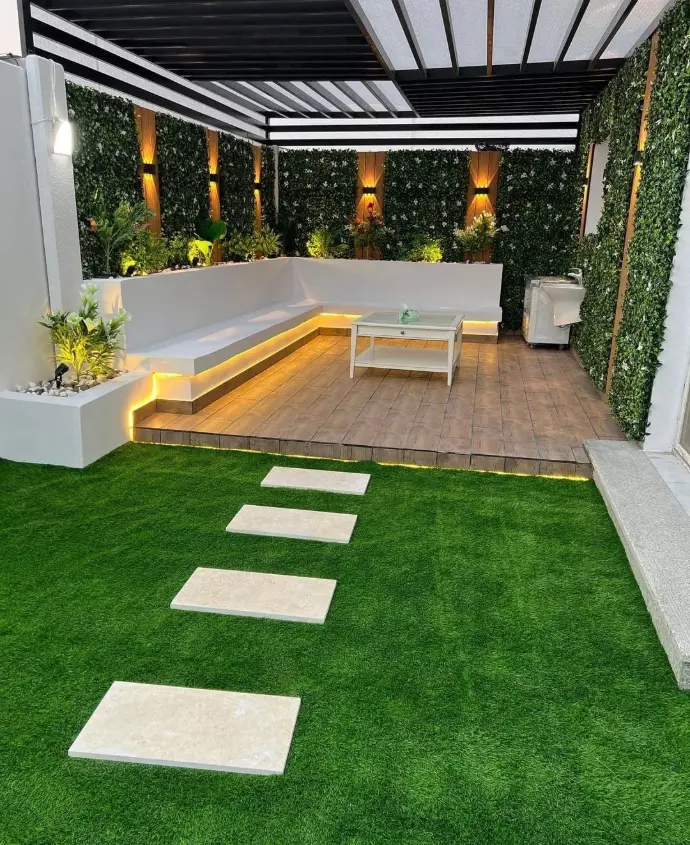 Indoor artificial lawn with wooden seating and plant decor