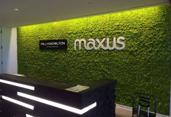 Brand name Maxxus displayed on green vertical garden wall