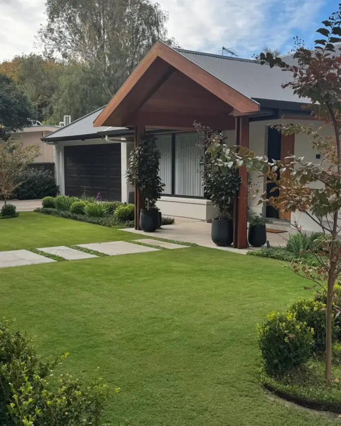 Small lawn in front of residential house with natural grass