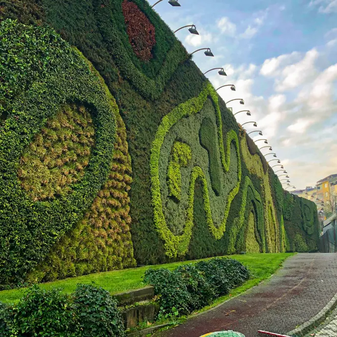 Creative vertical wall garden with layered design on building