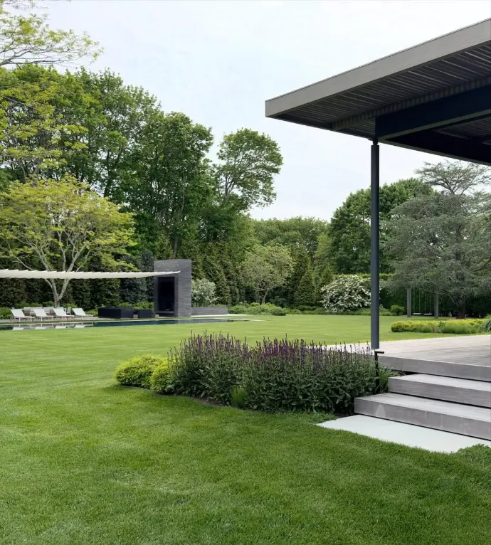 Lawn area with pergola and potted plants near entrance