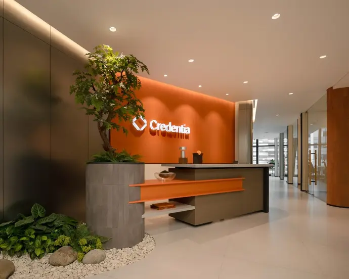 Reception area with warm lighting and potted plant decor