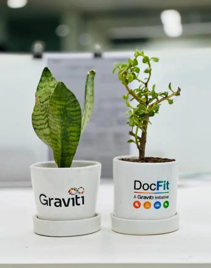 Indoor plant decor display with branding at an event booth