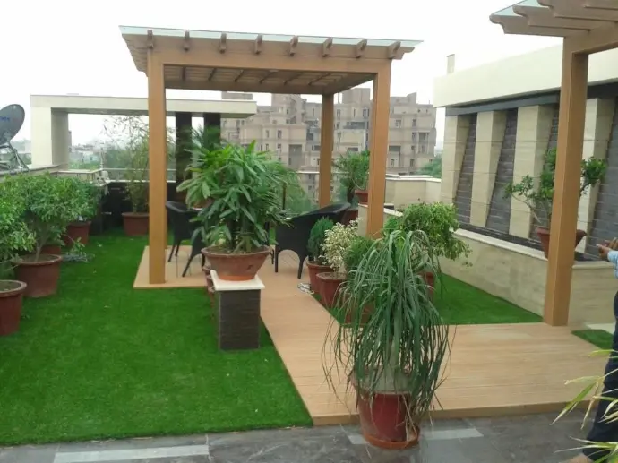 Wooden pergola with hanging plants and garden seating
